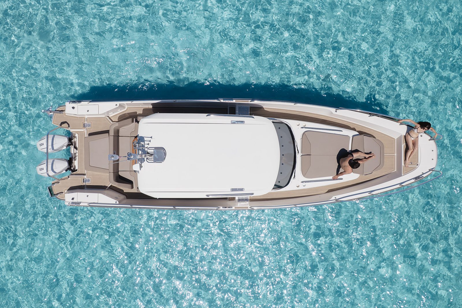 Overhead view of the Nimbus T11 at anchor over clear turquoise water off Sithonia